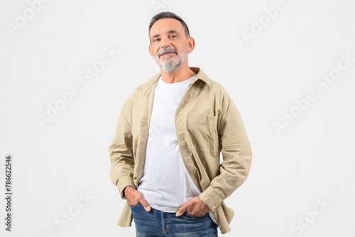 Smiling senior man in casual attire on white background