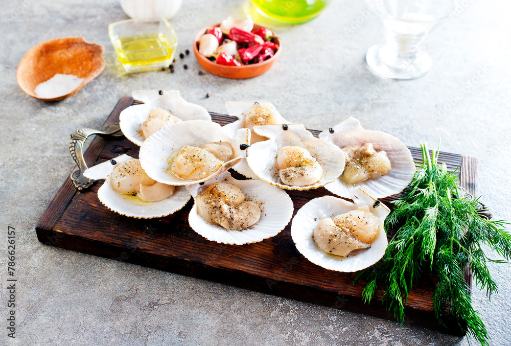 From above fresh appetizing scallop with shell served on wooden boars From above fresh appetizing scallop with shell served on wooden boars