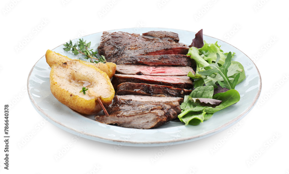 Pieces of delicious roasted beef meat, caramelized pear and greens isolated on white