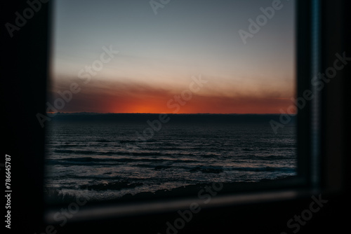 Tranquil seaside sunset view through window in Larino, Galicia photo