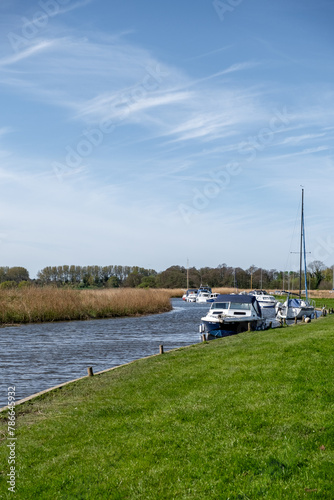 Leisure boats and motor boats moored in Upton Dyke on the Bure River, Norfolk Broads