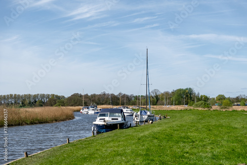Leisure boats and motor boats moored in Upton Dyke on the Bure River, Norfolk Broads