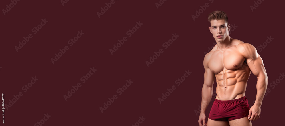 Muscular Caucasian male model posing in maroon briefs against a plain background, concept for fitness, masculinity, or bodybuilding-related themes