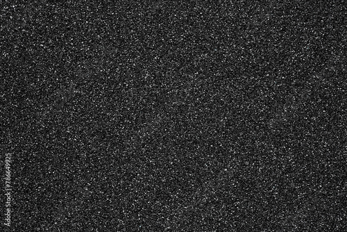 Black sand beach texture as background, top view. Macro photography. Black sand background.