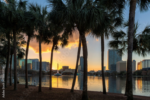 Orlando city skyline at sunset with fountain view of Orlando in Lake Eola Park, Florida, USA