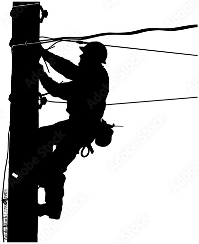 silhouette of a lineman working on an electrical pole  photo