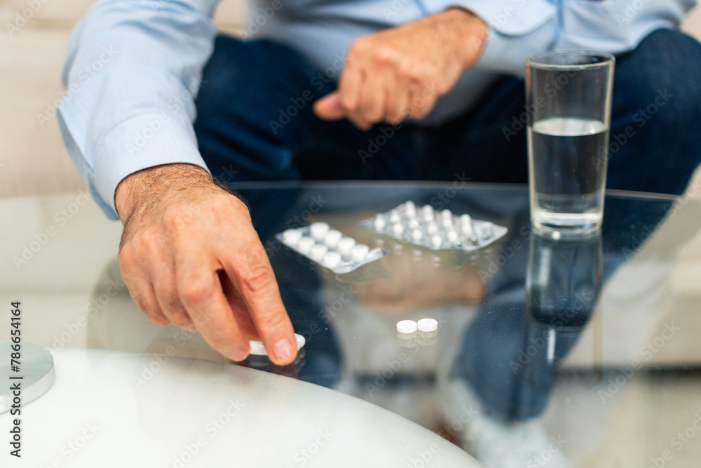 Hands with pills. Senior man hands with medical pill and glass of water. Mature old senior grandfather taking medication cure pills vitamin. Age prescription medicine healthcare therapy concept