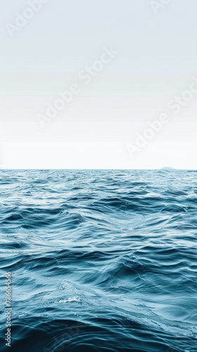 Calm ocean water surface with clear sky.