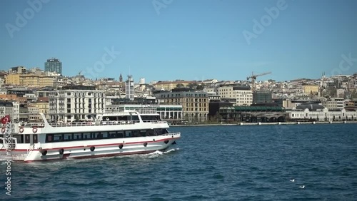 Bosphorus cruise by tourist boat in April. Sailing through the Bosphorus Strait from the Asian side to the European side. Zoom minus from Passing by Galataport. photo