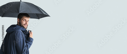 Handsome man with umbrella on white background