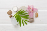 Composition with orchids, spa products on wooden background, top view