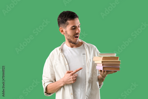Young man pointing at stack...