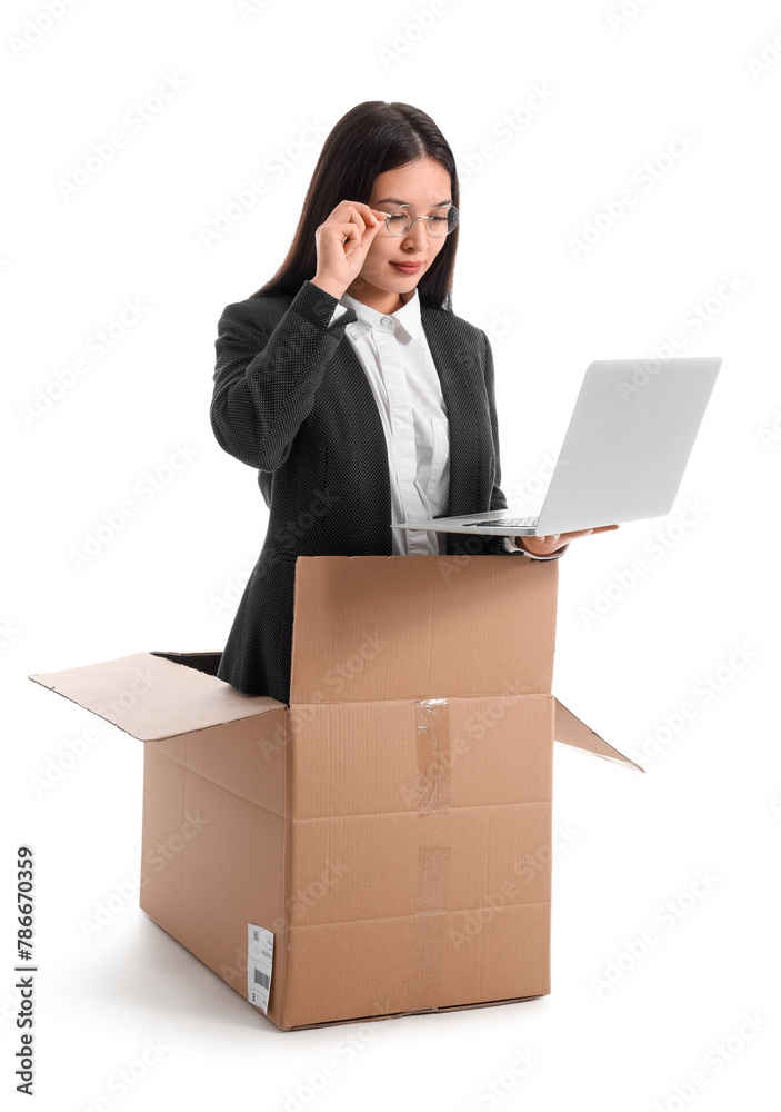 Funny Asian businesswoman with laptop sitting in cardboard box on white background Funny Asian businesswoman with laptop sitting in cardboard box on white background