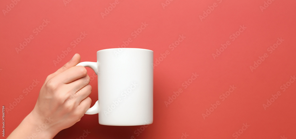 Hand Holding Blank Coffee Mug By Handle on Color Background Hand Holding Blank Coffee Mug By Handle on Color Background