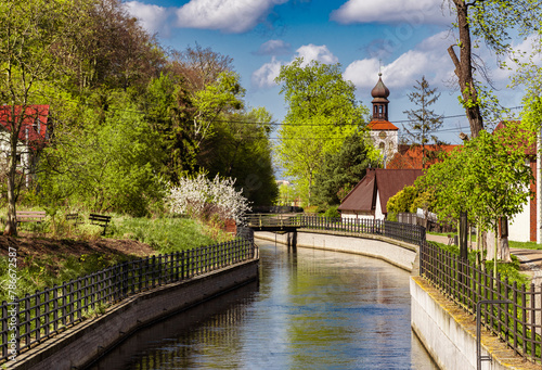 Beautiful spring countryside in Europe. Ancient church on the canal