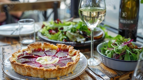 warm beets and chevre pie, side dish and glass of white wine ,lunch moment