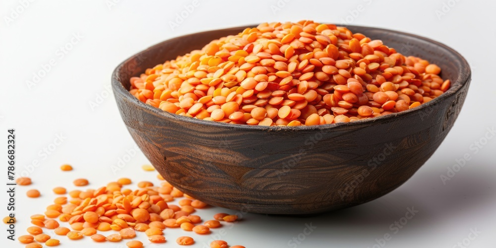A rustic wooden bowl filled with vibrant red lentils. Perfect for food and cooking concepts A rustic wooden bowl filled with vibrant red lentils. Perfect for food and cooking concepts