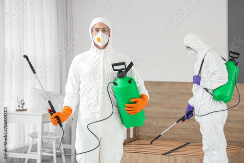 Male workers in hazmat suit...