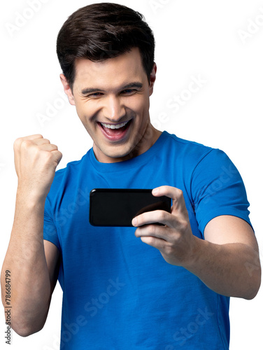 Handsome young male gamer clenching his fist with smiling face while playing game on mobile phone PNG file no background 