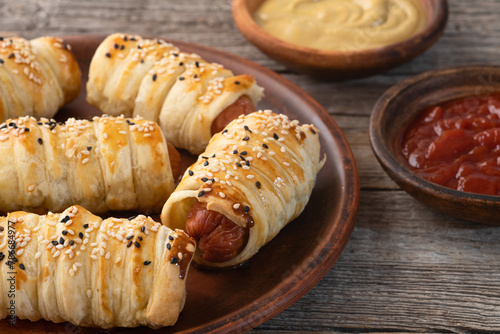 Homemade Sausage in dough rolls on plate