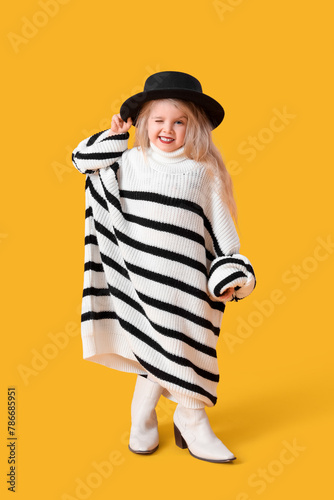 Playful young girl winking ...