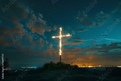 A cross on a hill with a sky background at night with stars and clouds in the sky and a city below