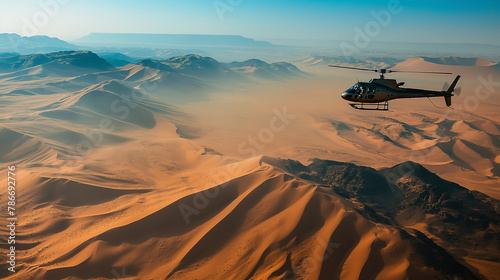 Helicopter flying over a vast desert landscape with sand dunes below. Happiness, love, health, courage, desire to live