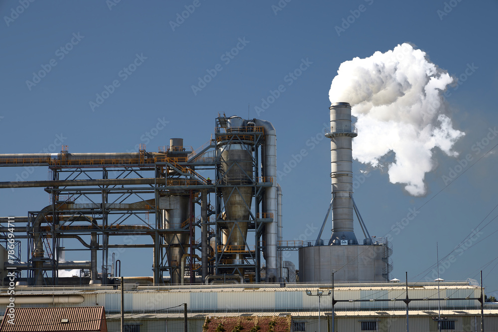 Padrón (Spain), April 16, 2024. Pollution. A factory chimney releasing a cloud of polluting smoke into the air. Padrón (Spain), April 16, 2024. Pollution. A factory chimney releasing a cloud of polluting smoke into the air.