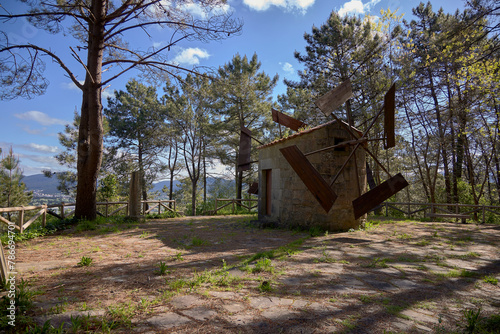 Valga (Spain), April 18, 2024. Windmill. Same as those used at the end of the 19th century and beginning of the 20th century. The tower is made of stone and the mechanism is simple, with 4 blades.