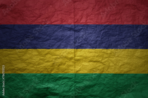 big national flag of mauritius on a grunge old paper texture background