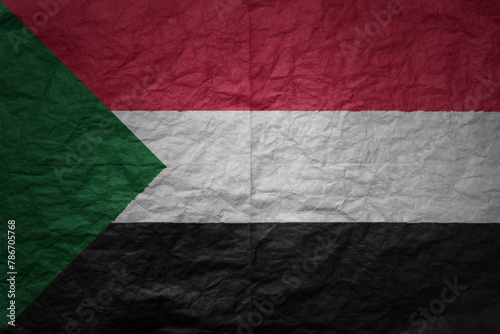 big national flag of sudan on a grunge old paper texture background
