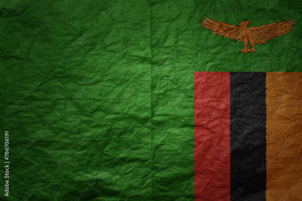 big national flag of zambia on a grunge old paper texture background