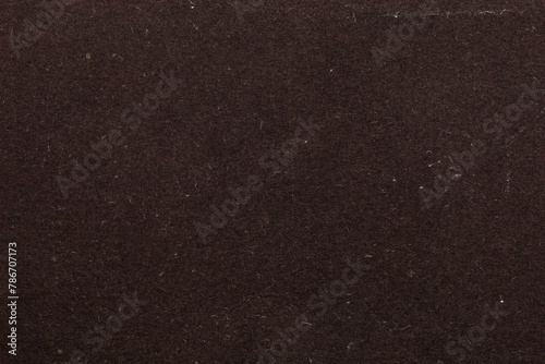 A dark brown background with a few specks of white