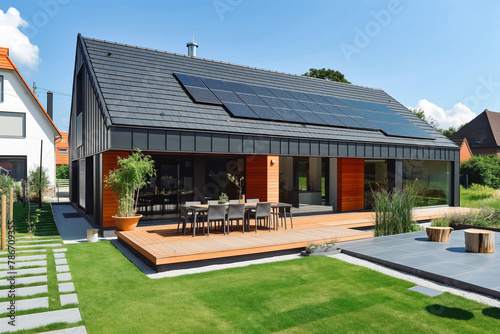 New photovoltaic system on the roof of suburban house. Modern eco friendly passive house with solar panels on the gable roof photo