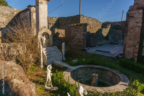 Garden inside ancient Casa di Marco Lucrezio sulla via Stabiana with marble sculptures in the ruins of Pompeii, Campania, Italy photo