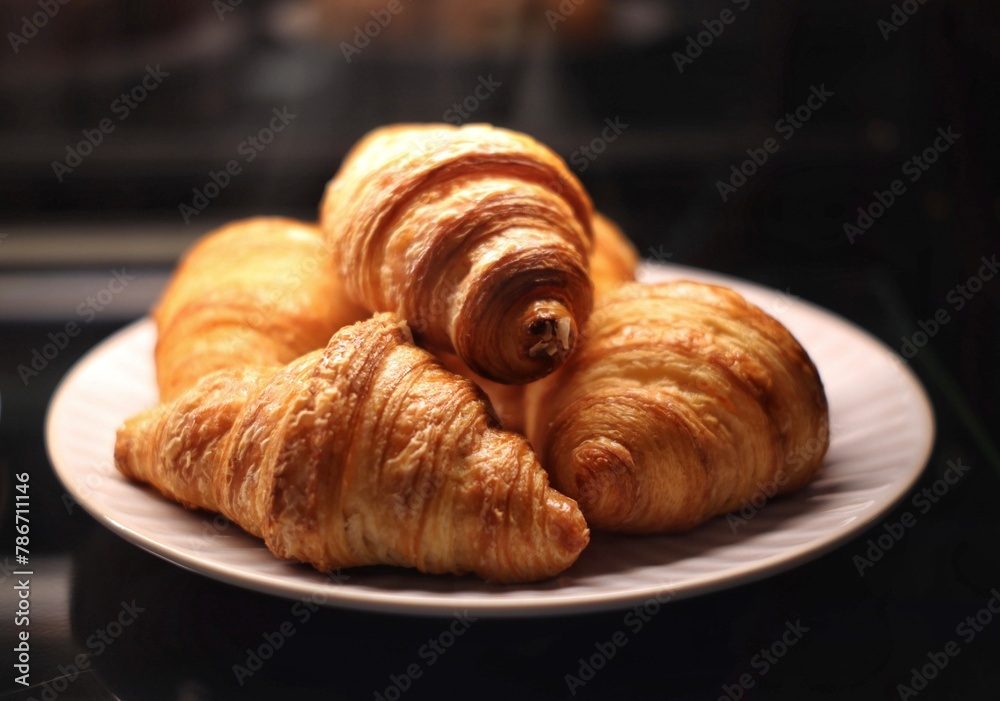 croissants on a plate on a black background