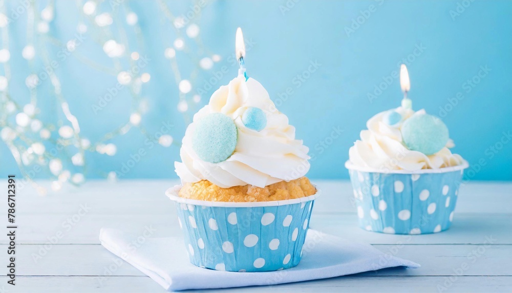 Blue Frosted Cupcakes with Candles on Light Blue Background - Boy's Party Theme Blue Frosted Cupcakes with Candles on Light Blue Background - Boy's Party Theme