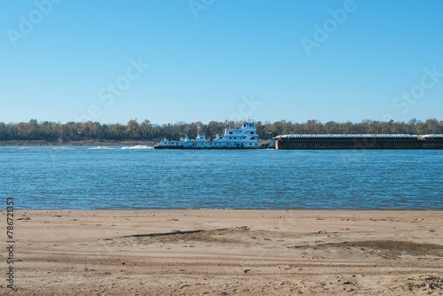 Mississippi River barge pushing cargo upriver near Memphis, TN