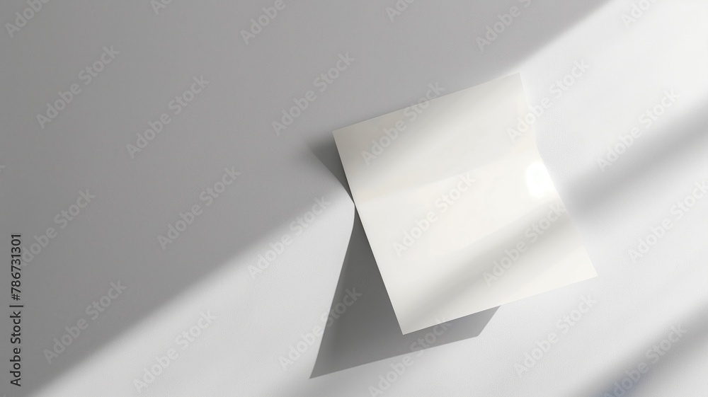 Blank white paper on surface with shadow divide Blank white paper on surface with shadow divide