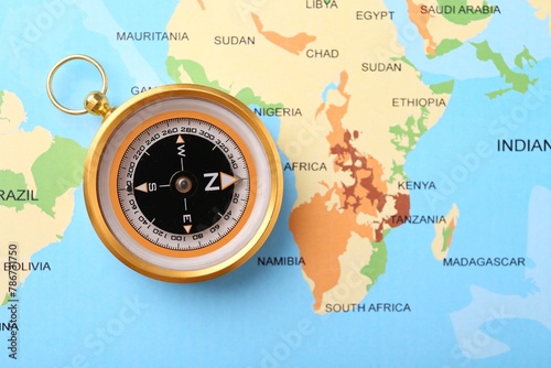 Compass on world map, top view. Navigation equipment