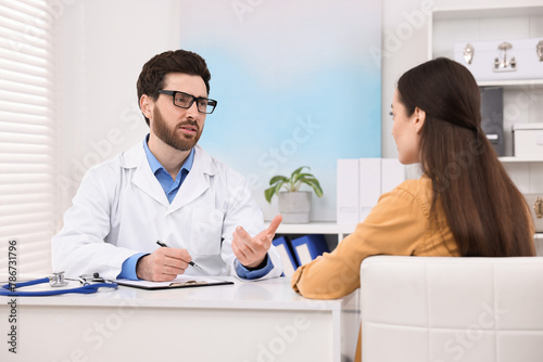 Doctor consulting patient during appointment in clinic