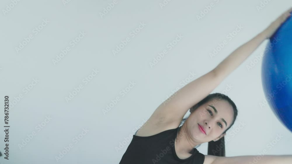 asian woman doing exercise lifting gymnastic ball asian woman doing exercise lifting gymnastic ball