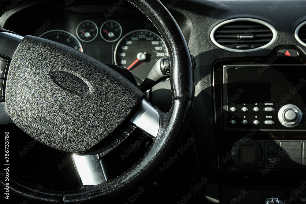 Fototapeta premium Black steering wheel and dashboard in car