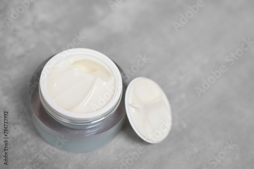 Body cream on grey table, closeup. Space for text