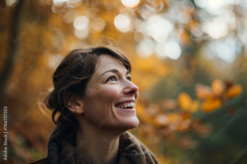 Portrait of happy young woman in autumn forest. Smiling girl.
