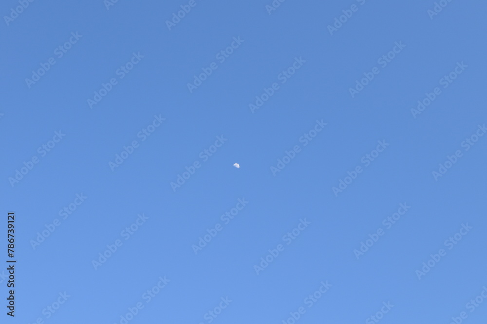 White Moon in a Blue Sky