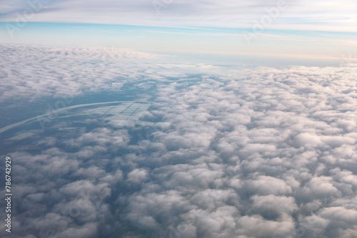 Aerial view of clouds over the Earth. Flying through the clouds in the morning 