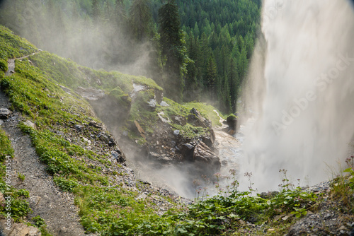  waterfall from a high cliff. water flow down.Streams of water crash on rocks and boulders. stormy stream of water with drops and splashes.Downward movement of water.