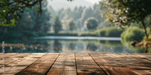 Peaceful scene of a calm lake viewed from a textured wooden pier surrounded by lush trees.
