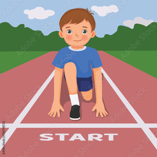 Cute little boy ready to run on starting position at race track